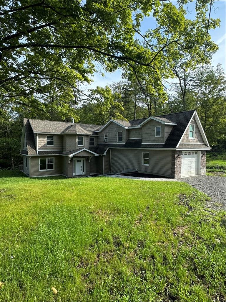 View of front facade with a garage and a front yard