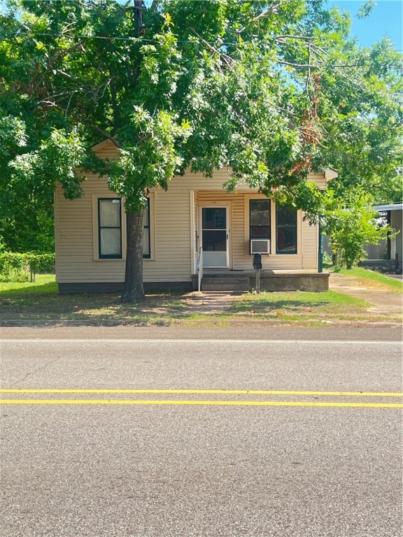 a house that has a tree in front of it