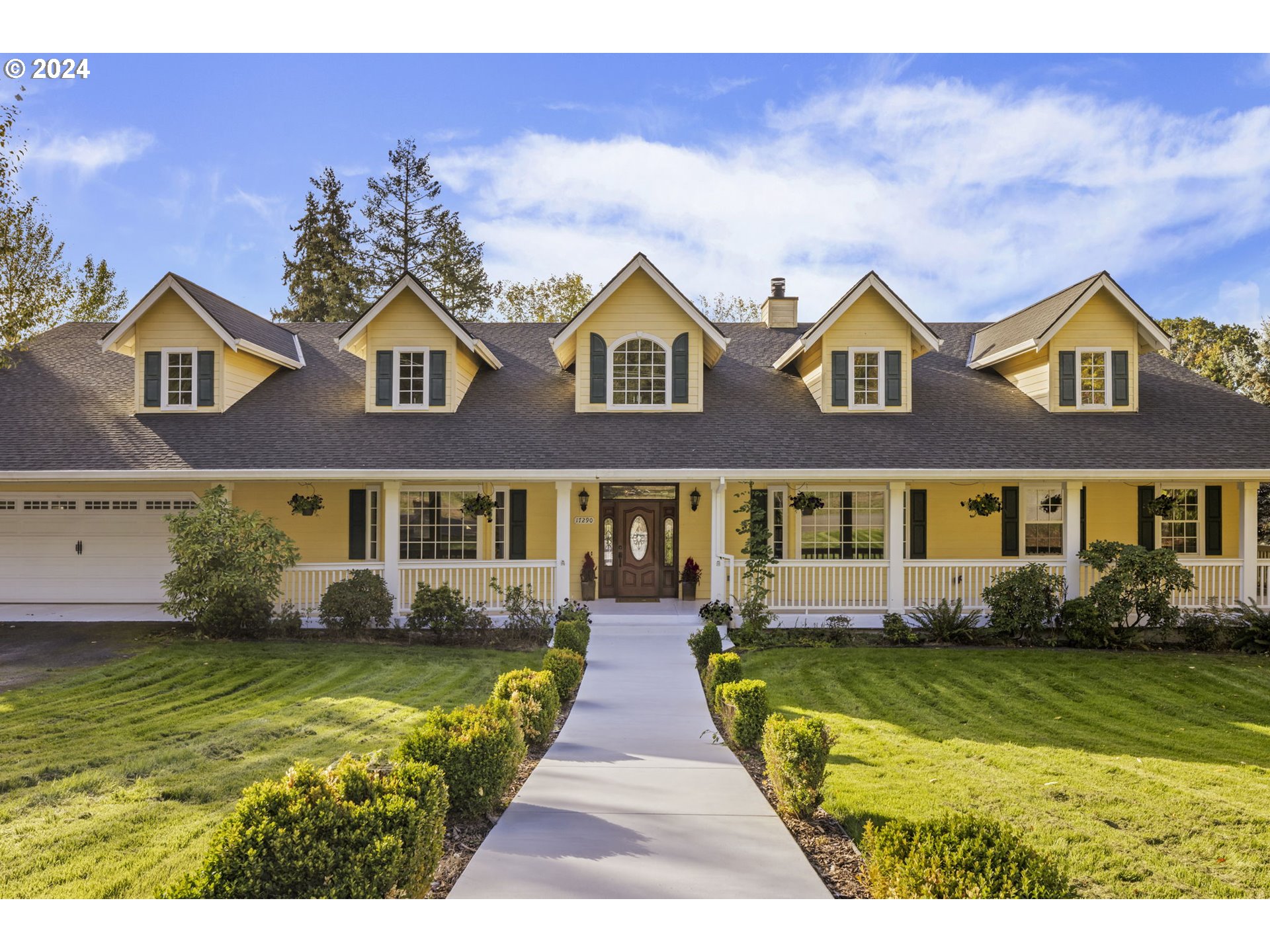 a front view of house with yard and green space