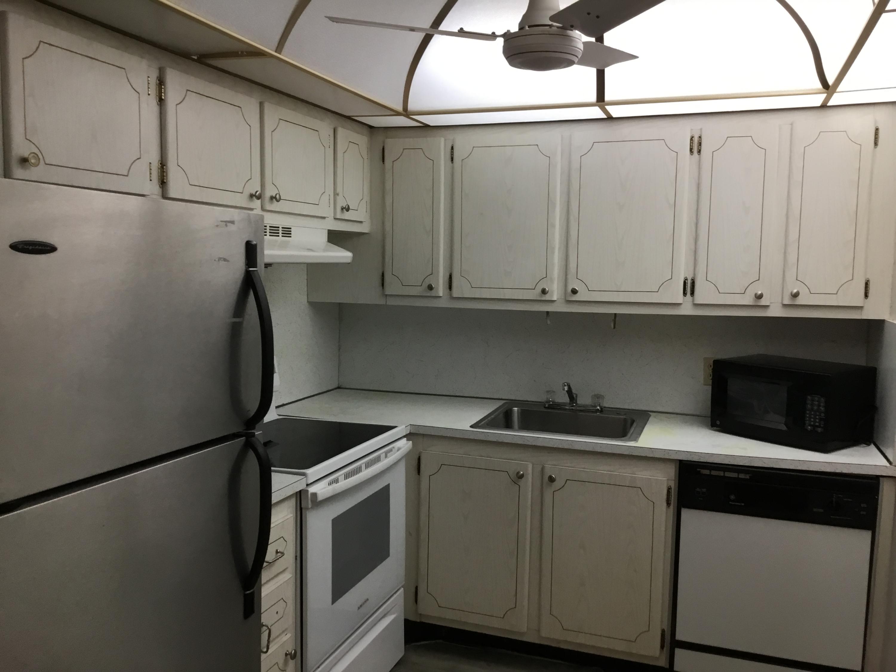 a kitchen with stainless steel appliances white cabinets and a sink