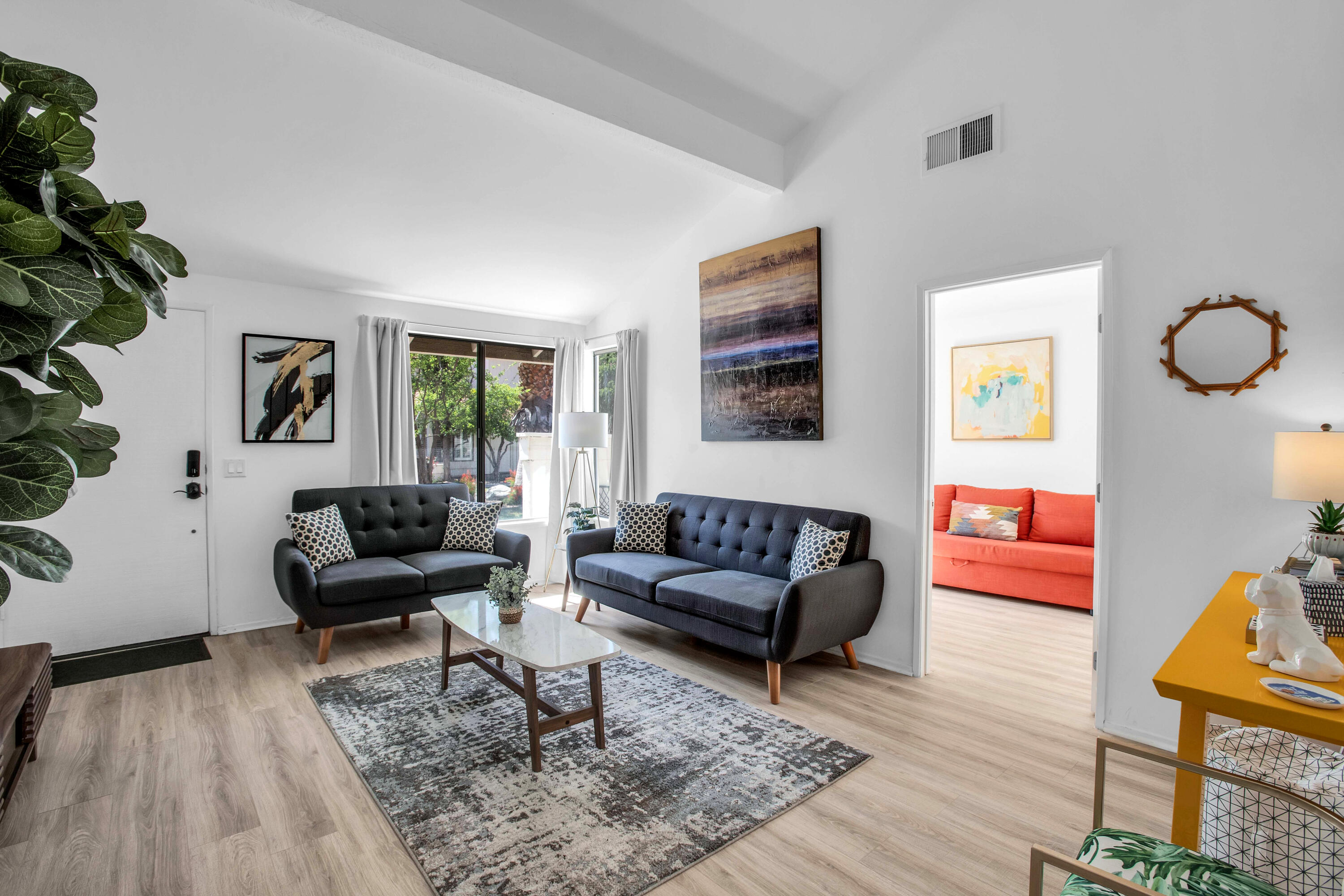 a living room with furniture and wooden floor