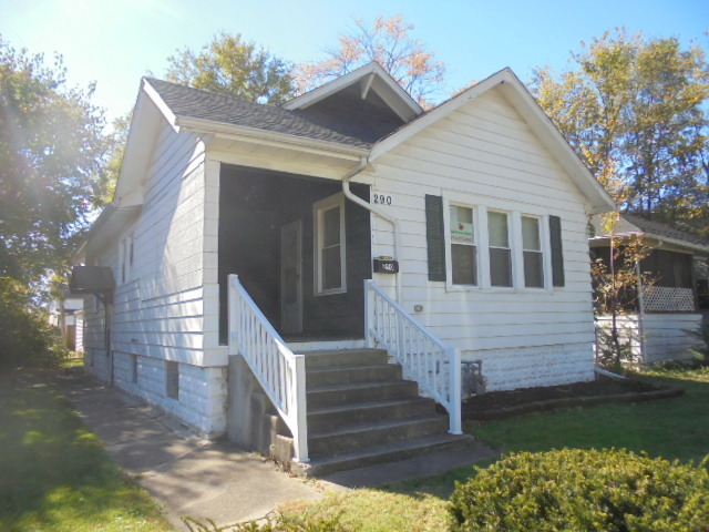 a view of a house with wooden fence