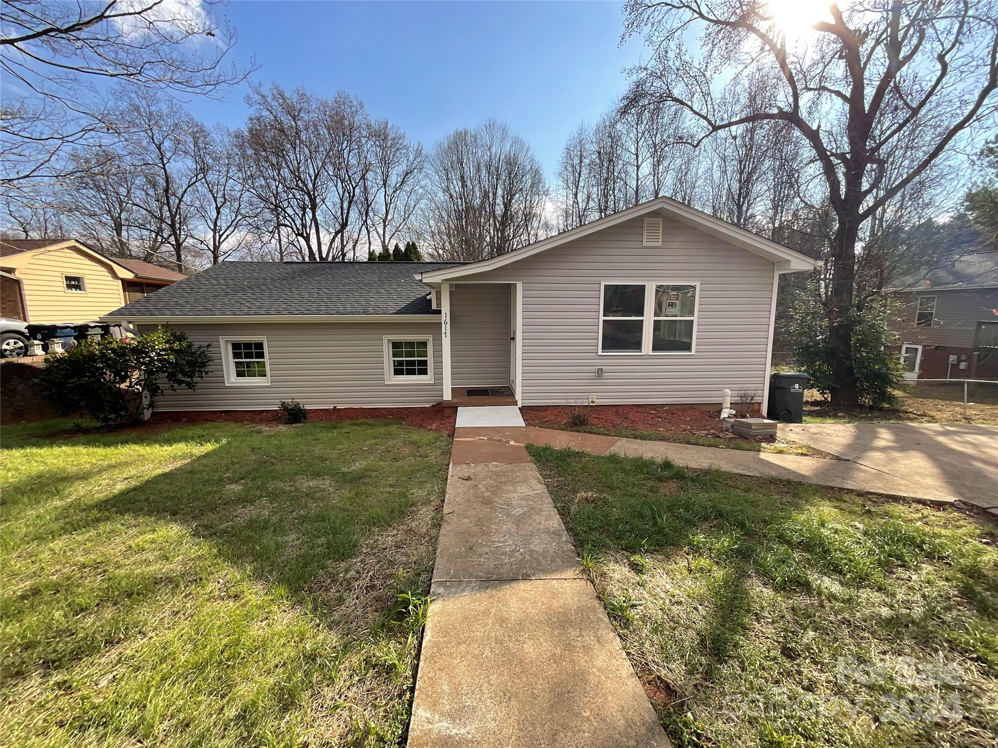 a view of a yard in front view of a house