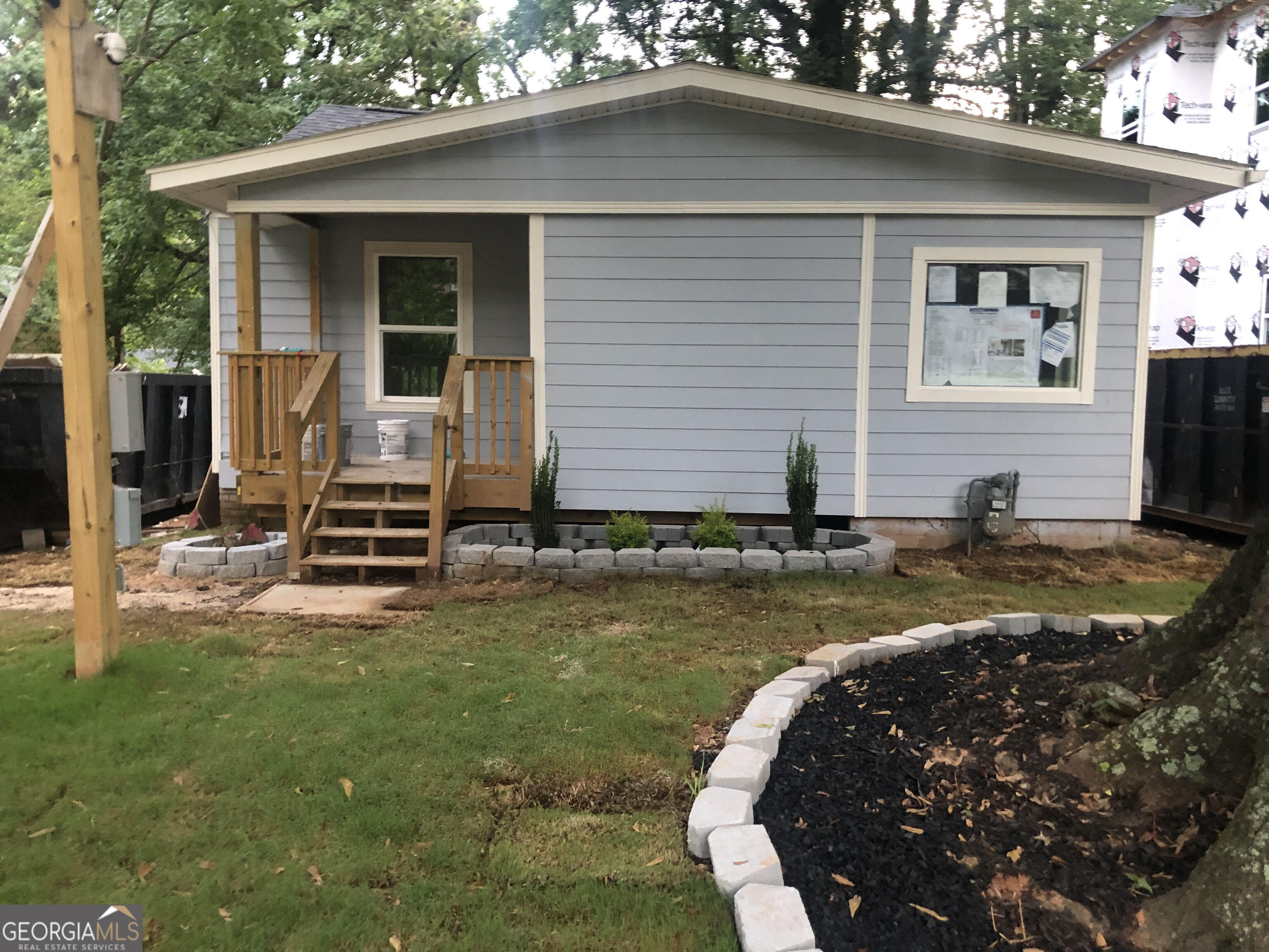 a view of a house with backyard and sitting area