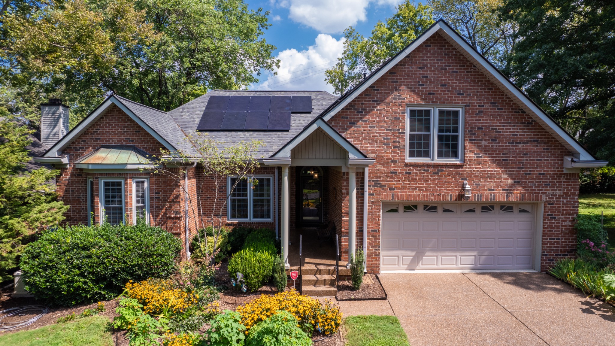 a front view of a house with garden