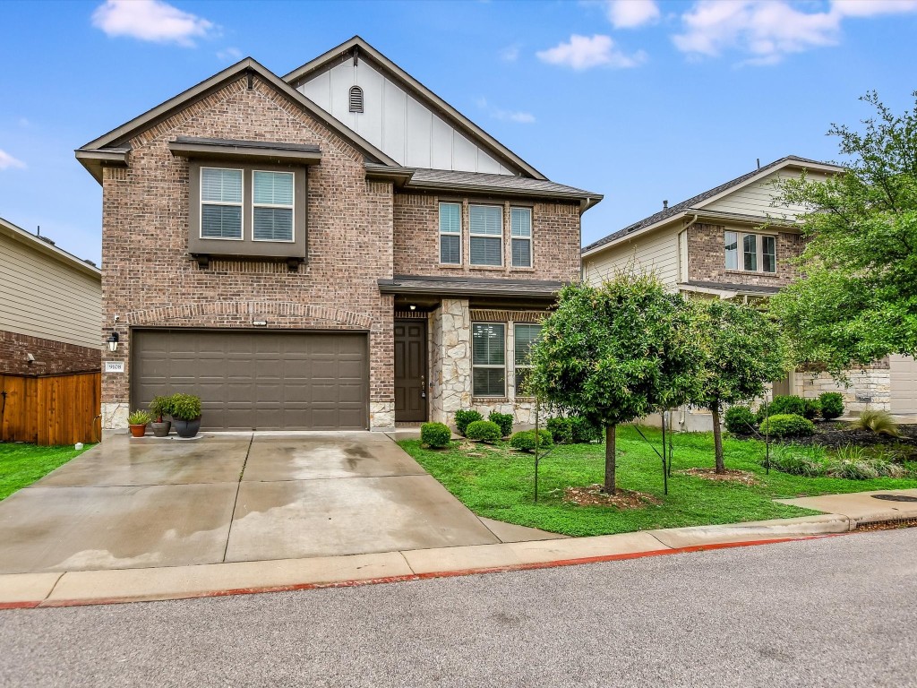 a front view of a house with a yard and garage