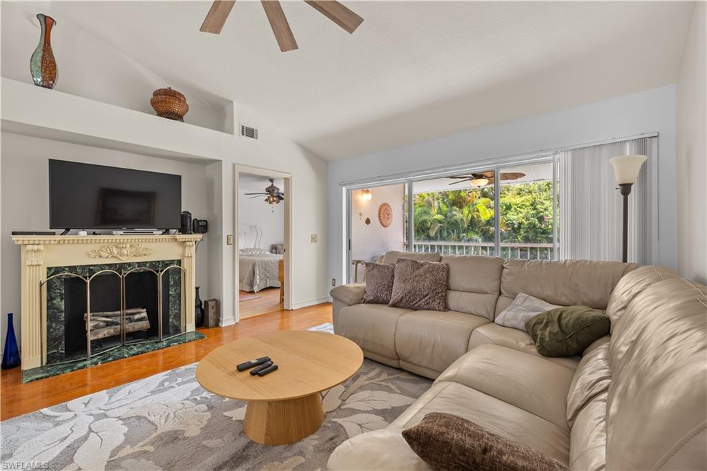 a living room with furniture a window and a fireplace