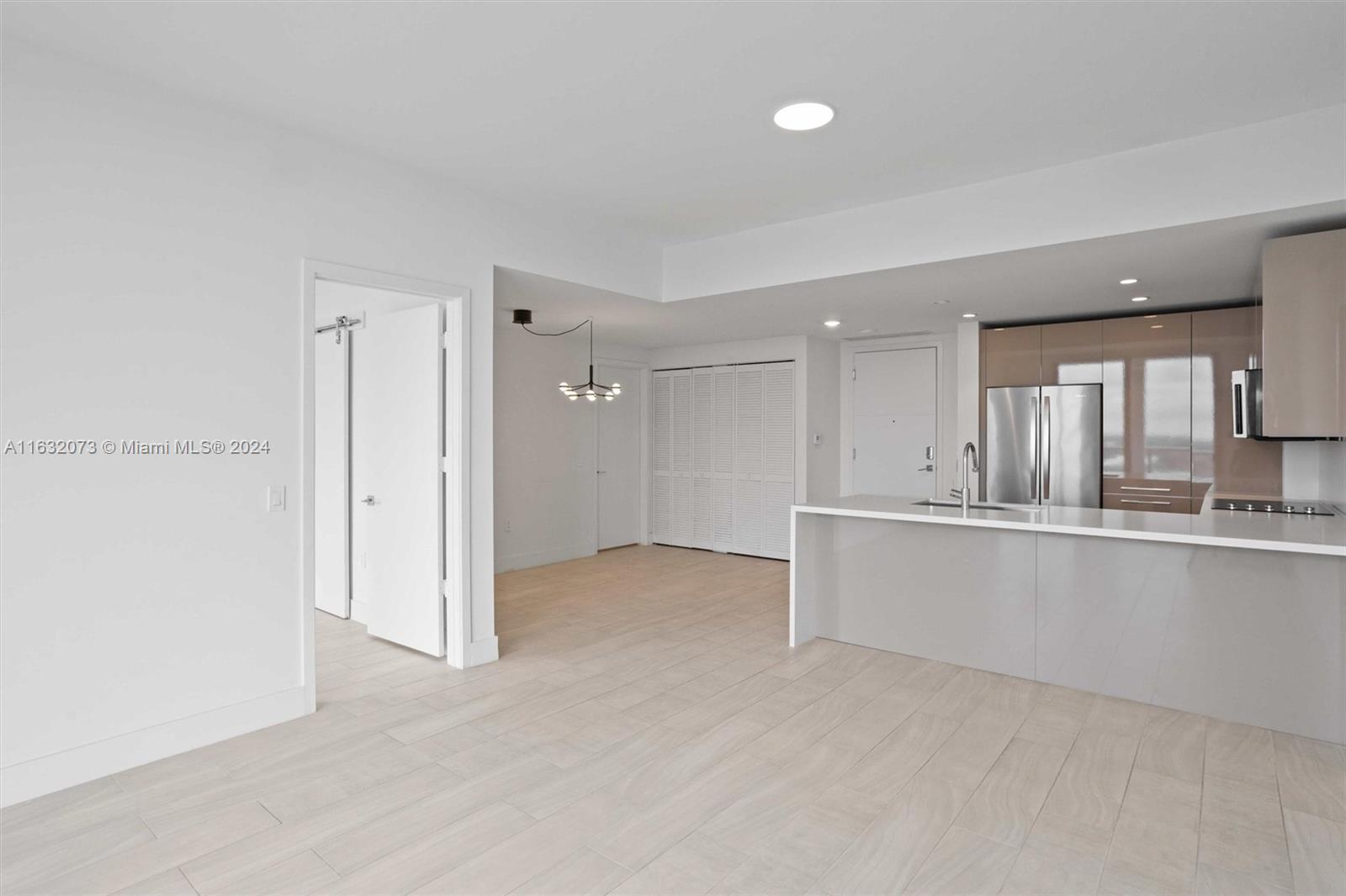 a view of a kitchen with a sink and a refrigerator