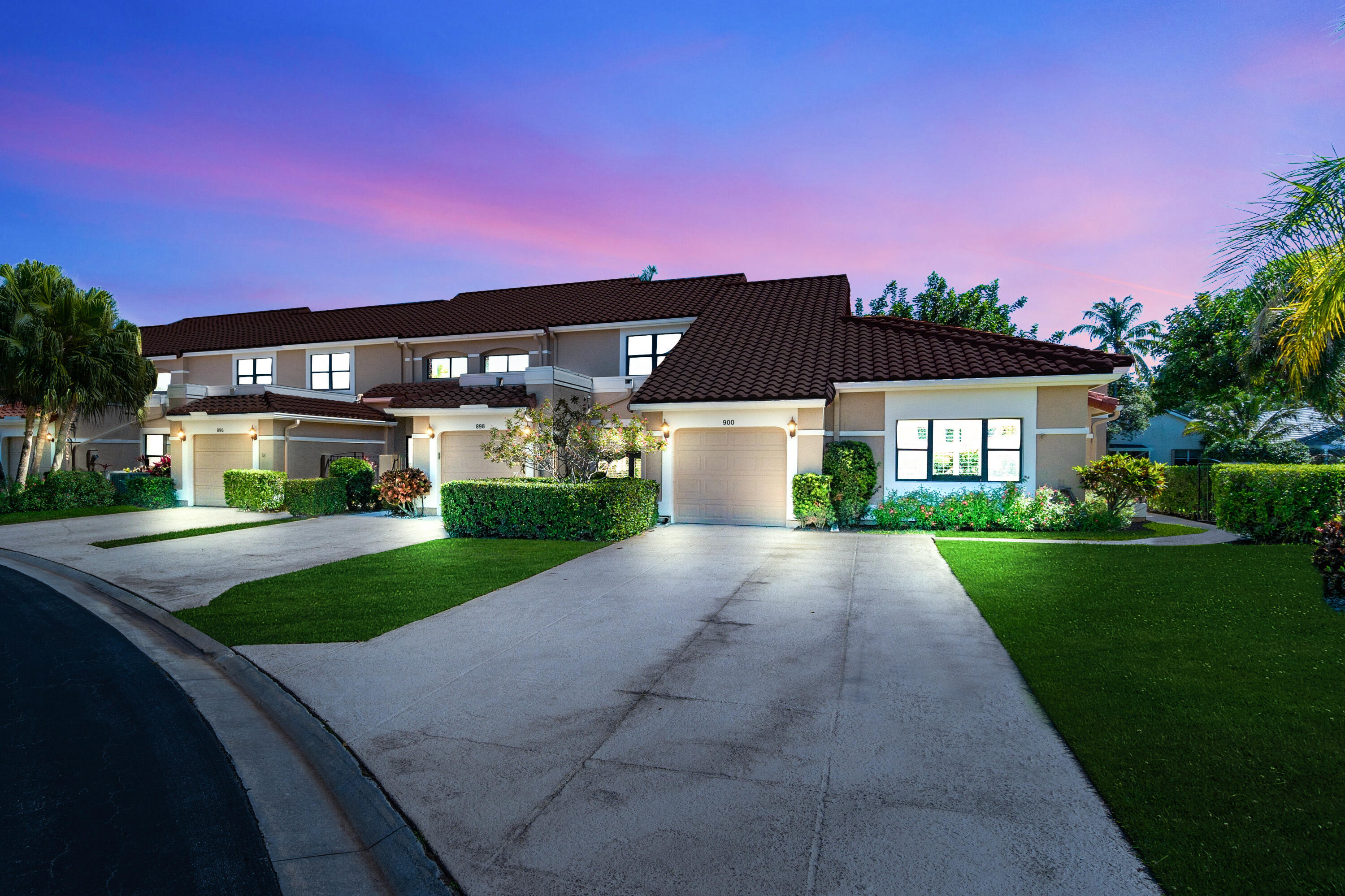 a front view of a house with a yard and a garage