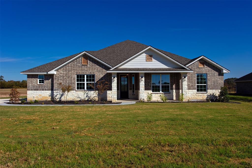 a front view of a house with a garden and porch