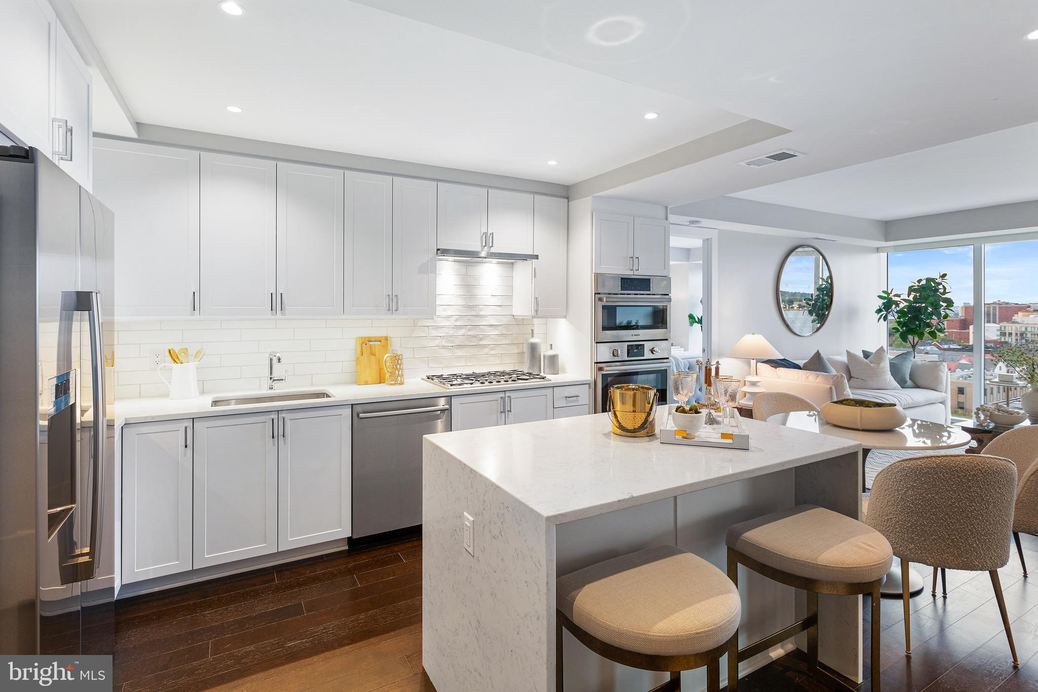 a kitchen with a dining table chairs and sink