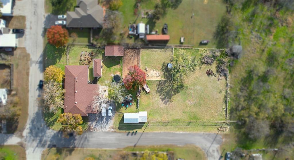 an aerial view of a house with a yard