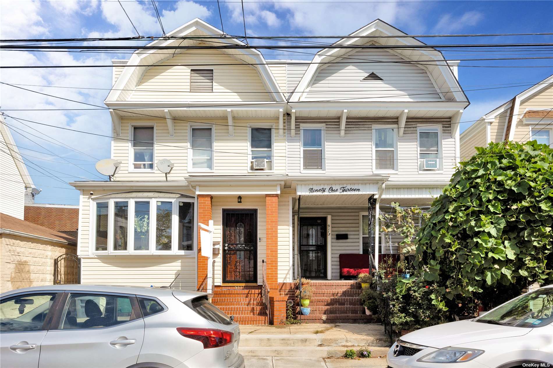 a front view of a residential apartment building with a yard