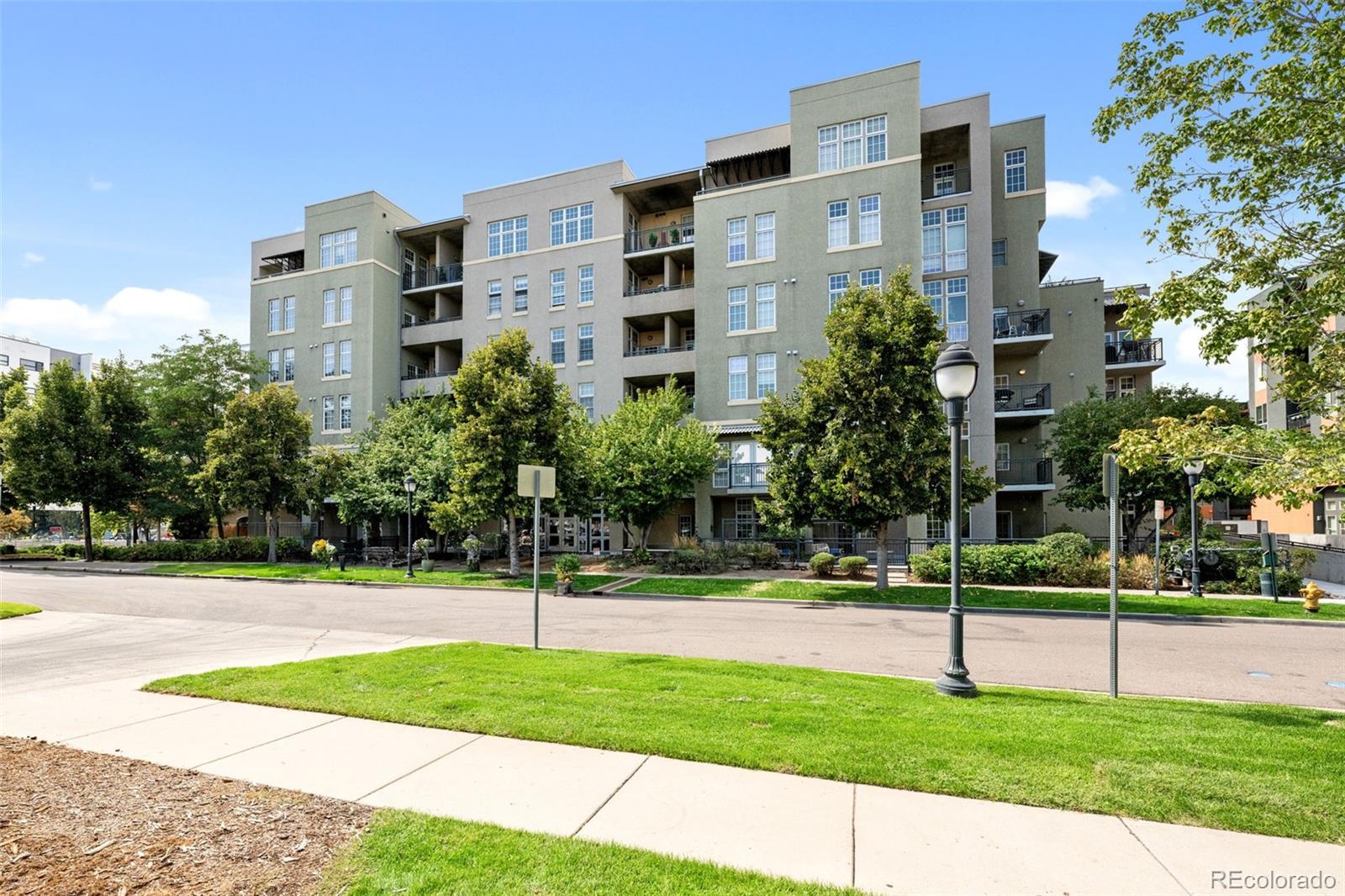 a view of a tall building next to a yard