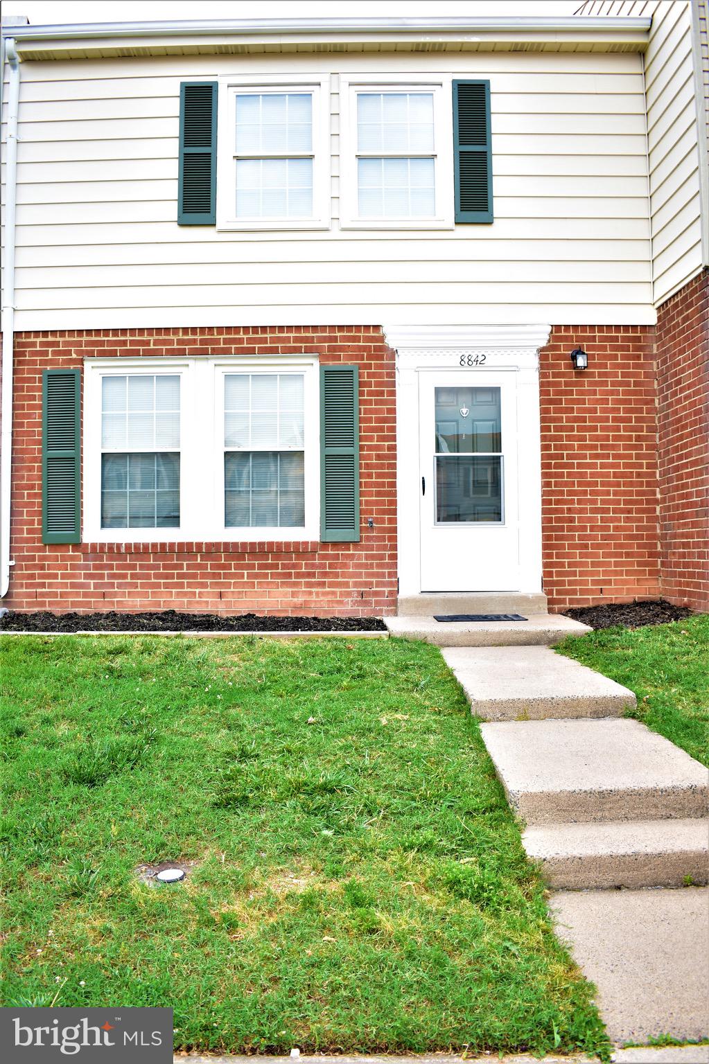 front view of a house with a yard