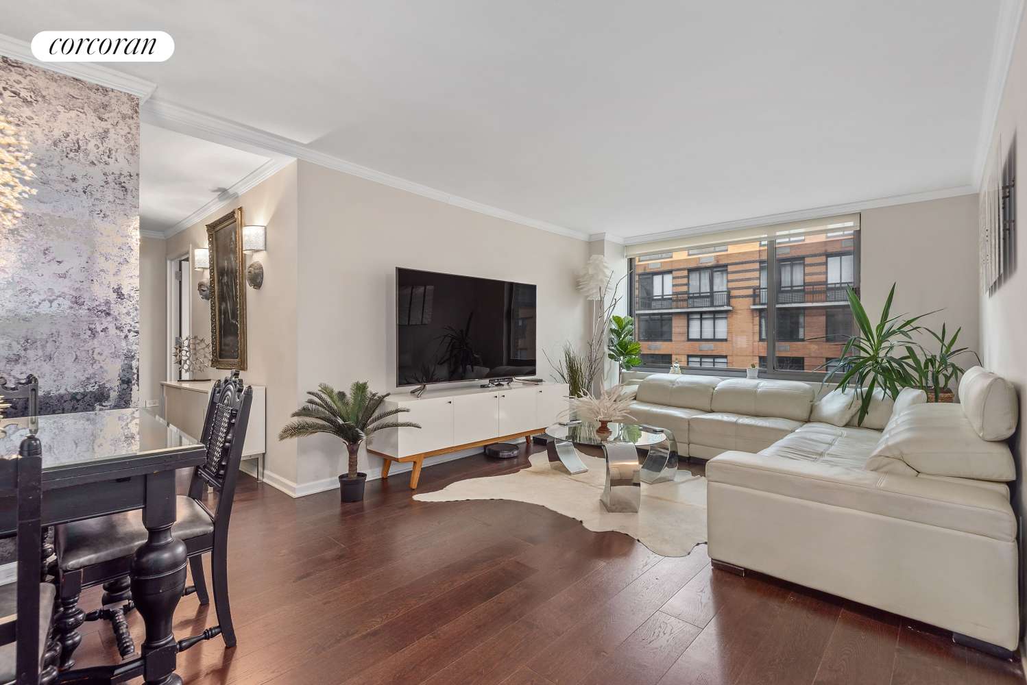 a living room with furniture wooden floor and a flat screen tv