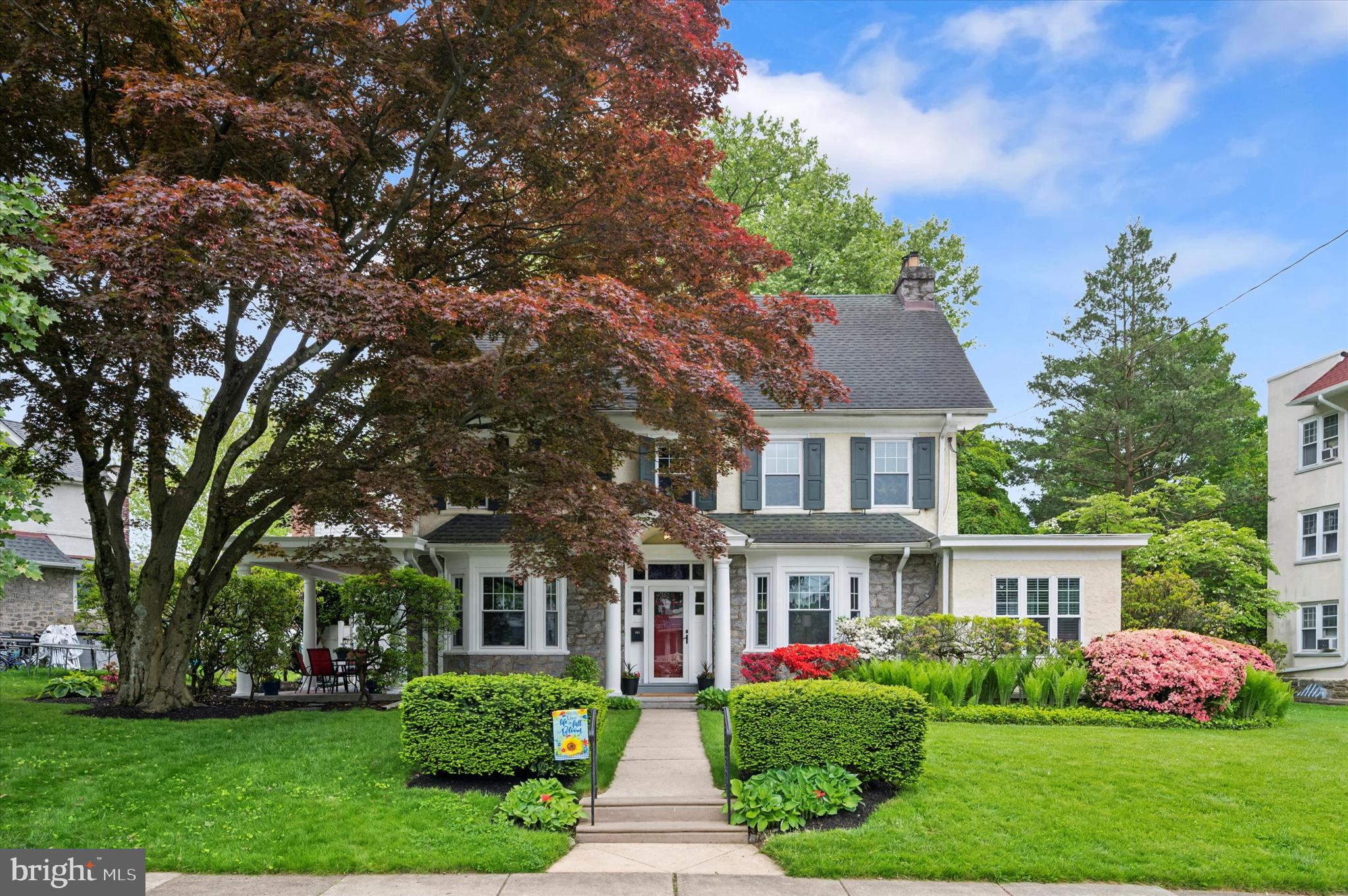 a front view of house with yard and green space