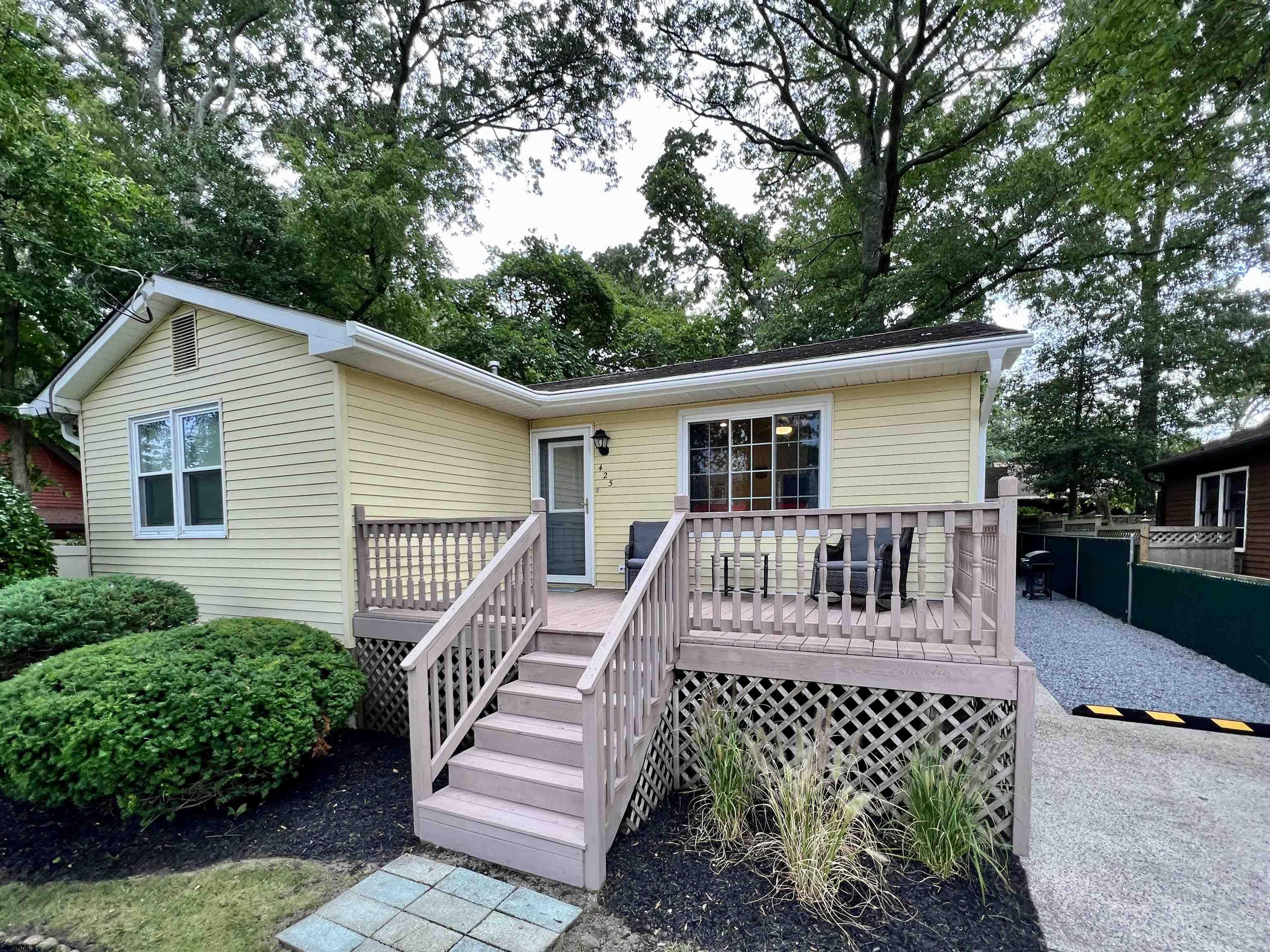 a view of a house with a chairs in a patio