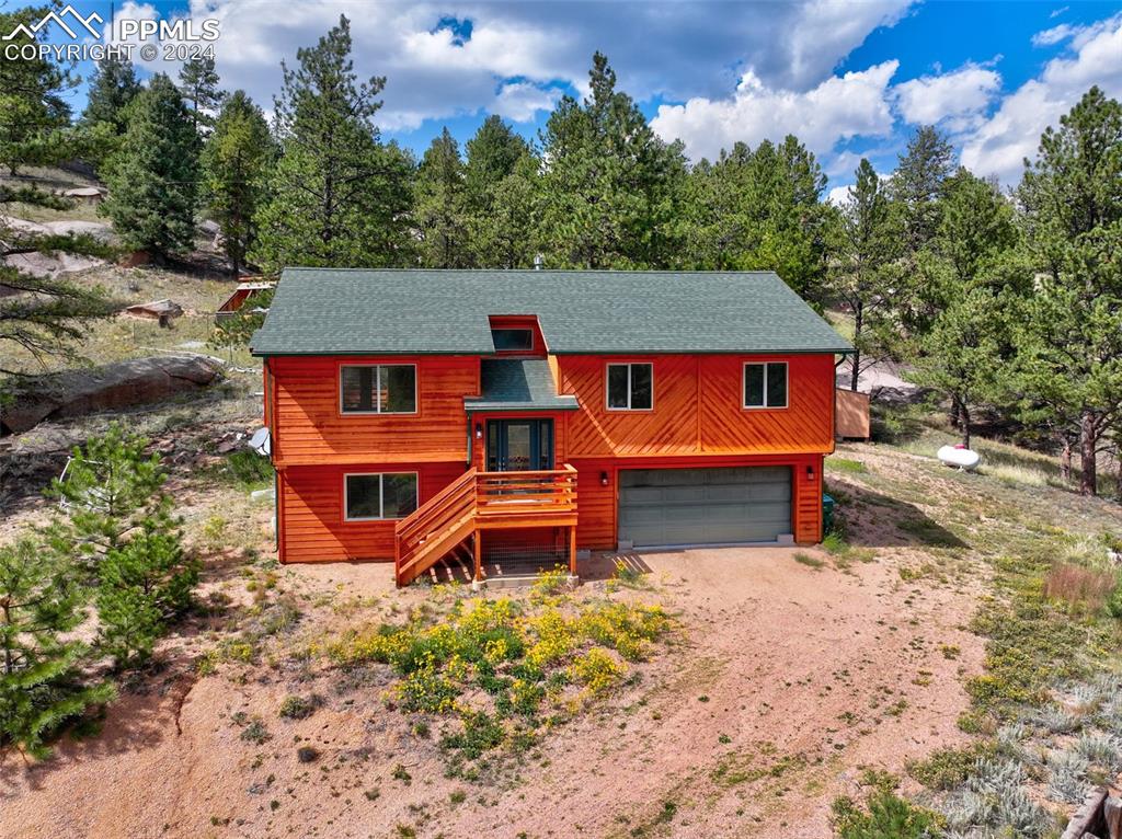 an aerial view of a house with a yard and sitting area