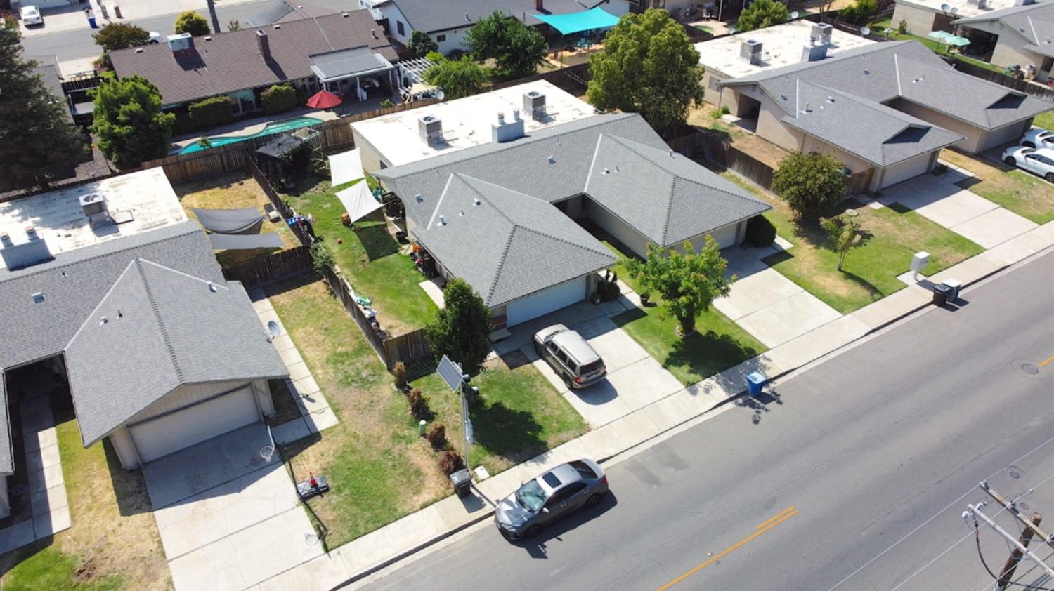 an aerial view of residential houses with outdoor space