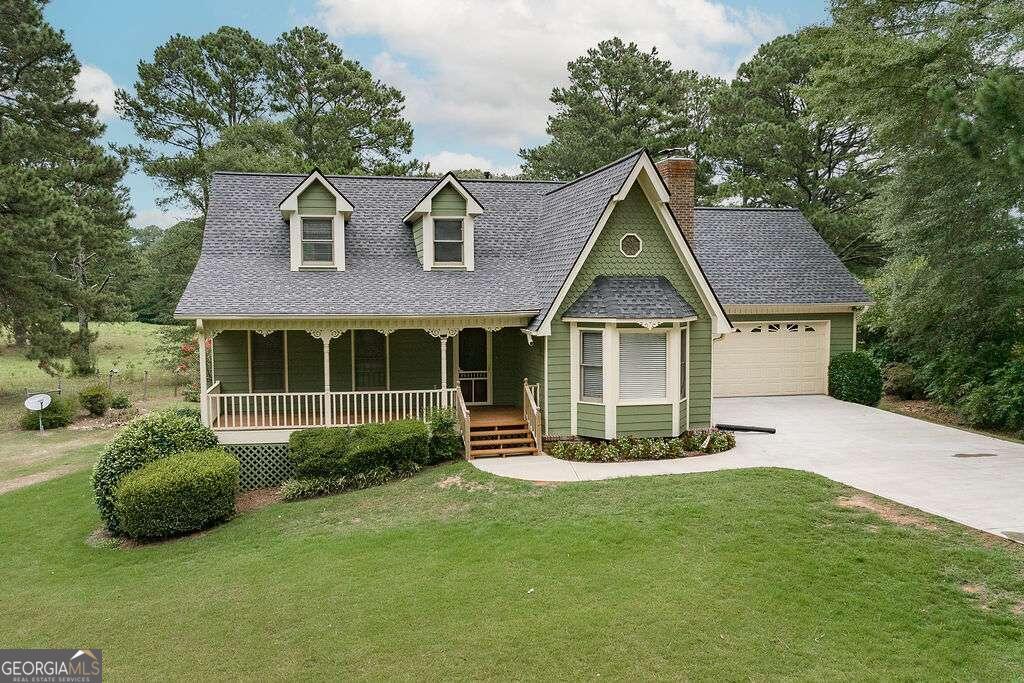 a front view of a house with a garden and plants