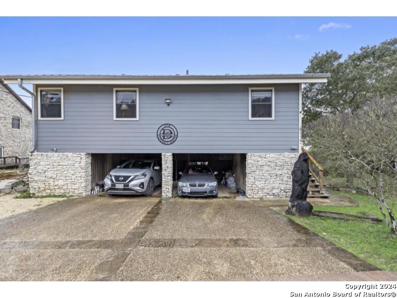 a view of a house with a yard and a garage