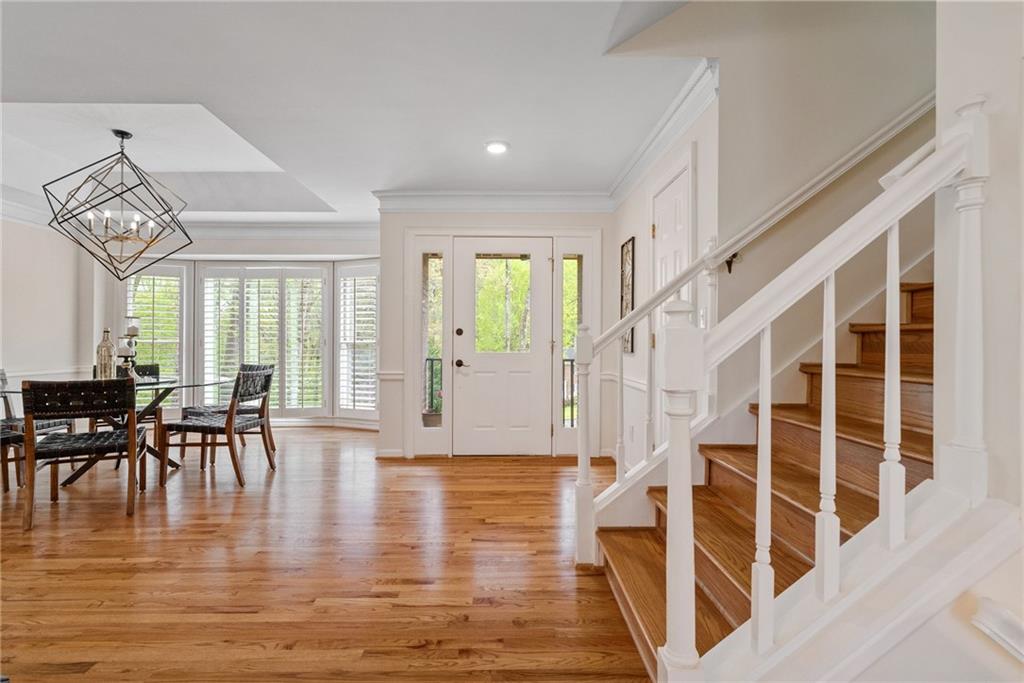 a view of a livingroom with furniture wooden floor and windows