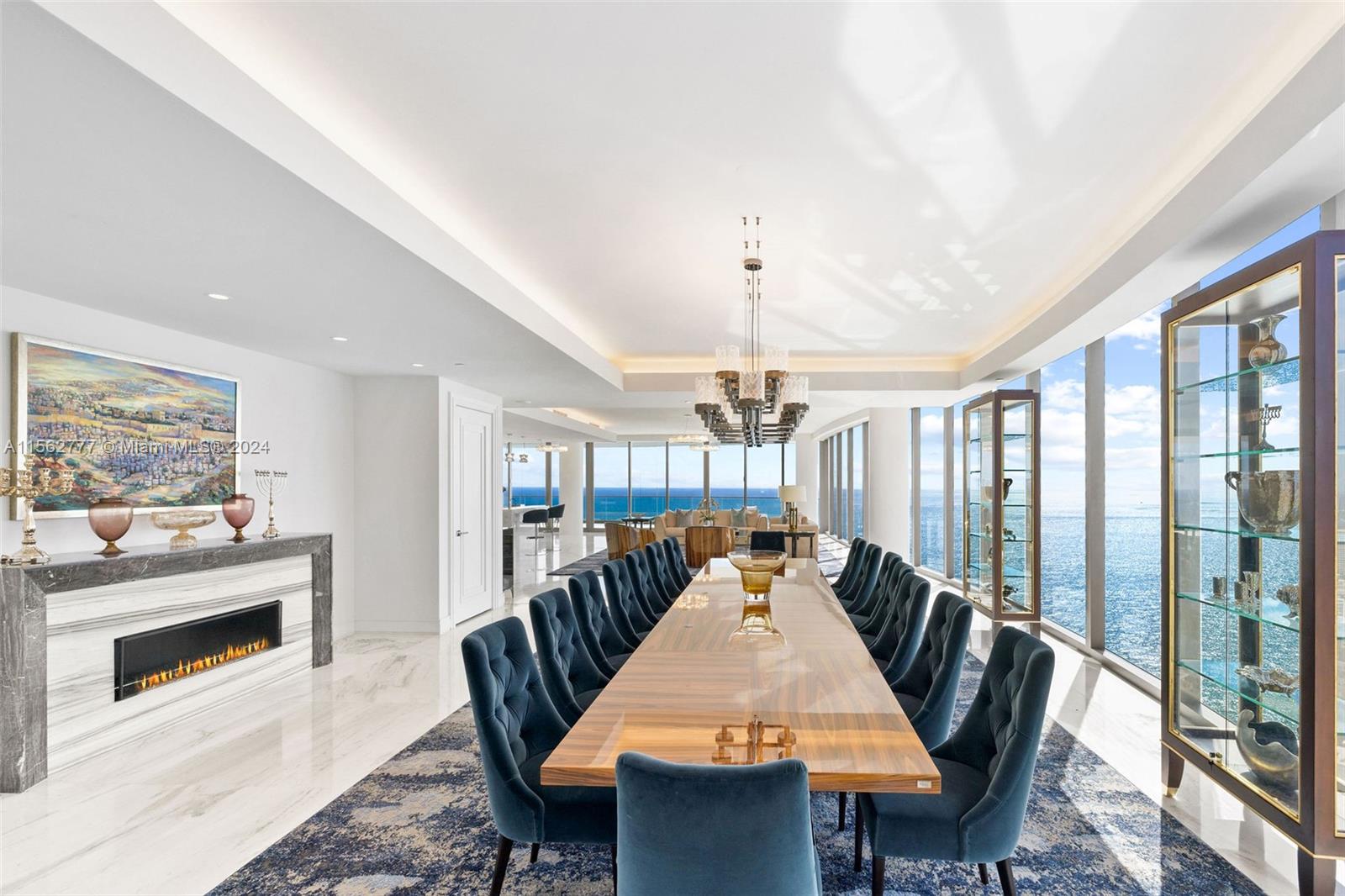 a dining room with furniture a chandelier and wooden floor