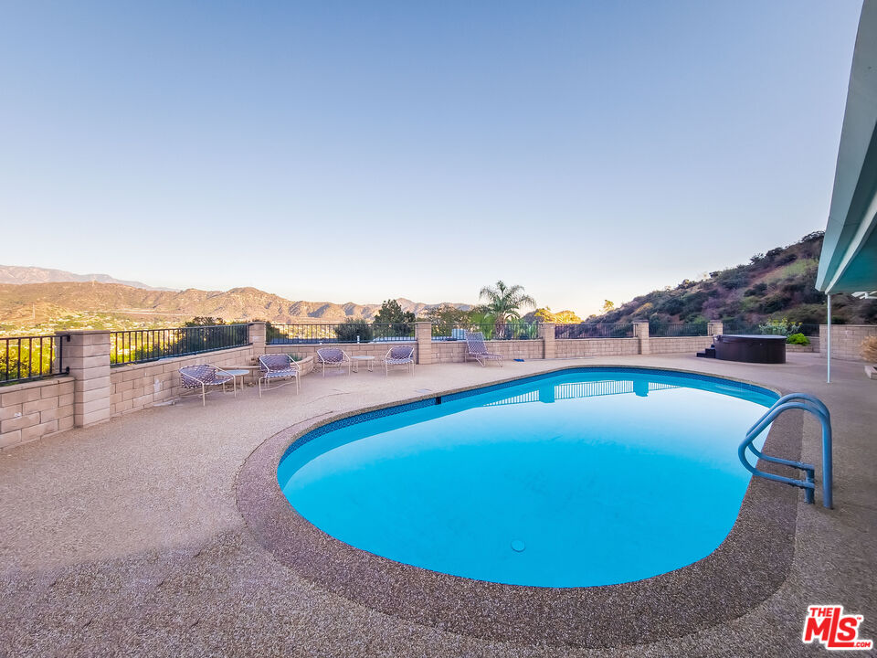 an outdoor space with pool and furniture