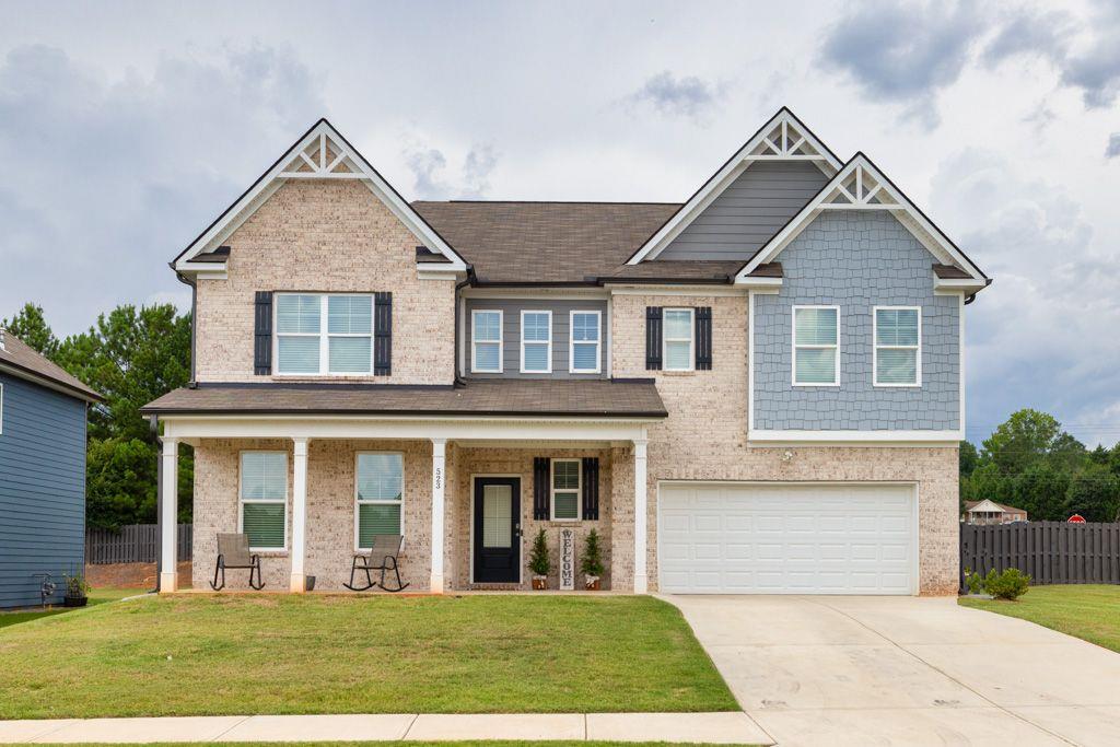 front view of brick house with a yard