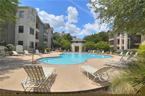 a swimming pool with outdoor seating and yard