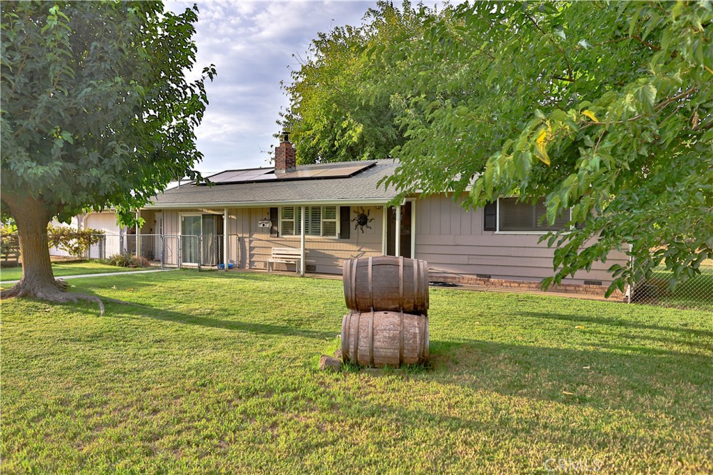 a front view of a house with a yard table and chairs