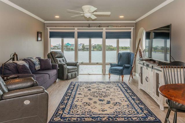 a living room with furniture and a floor to ceiling window