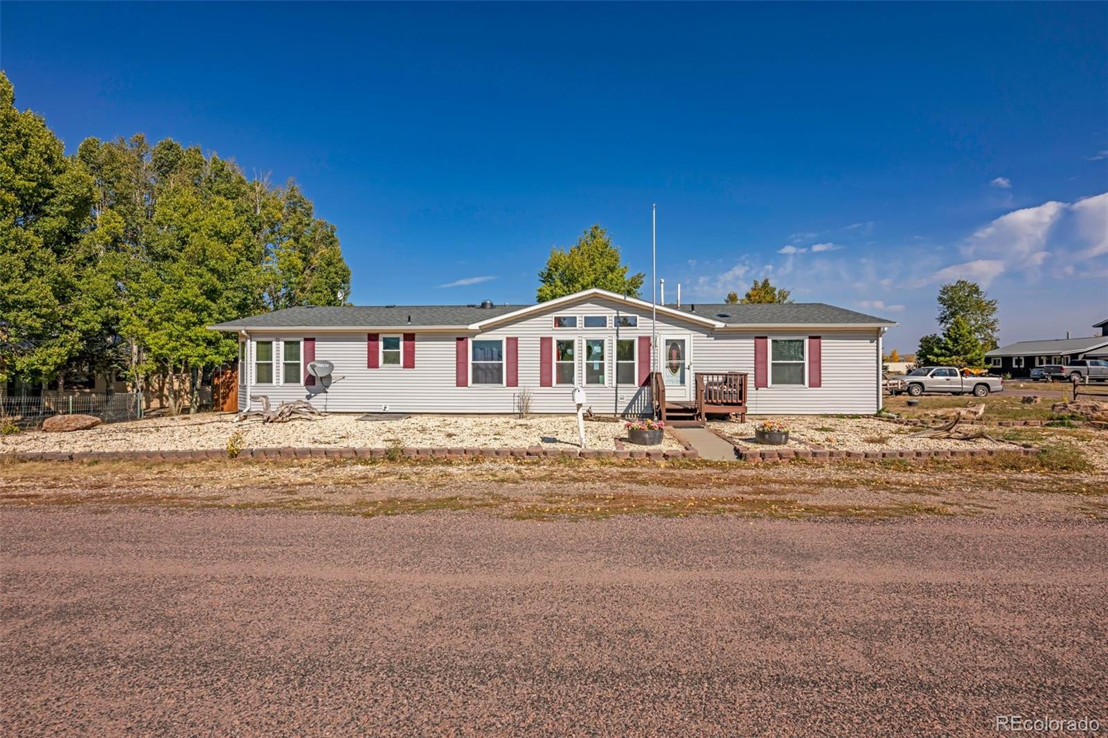 a front view of a house with a road