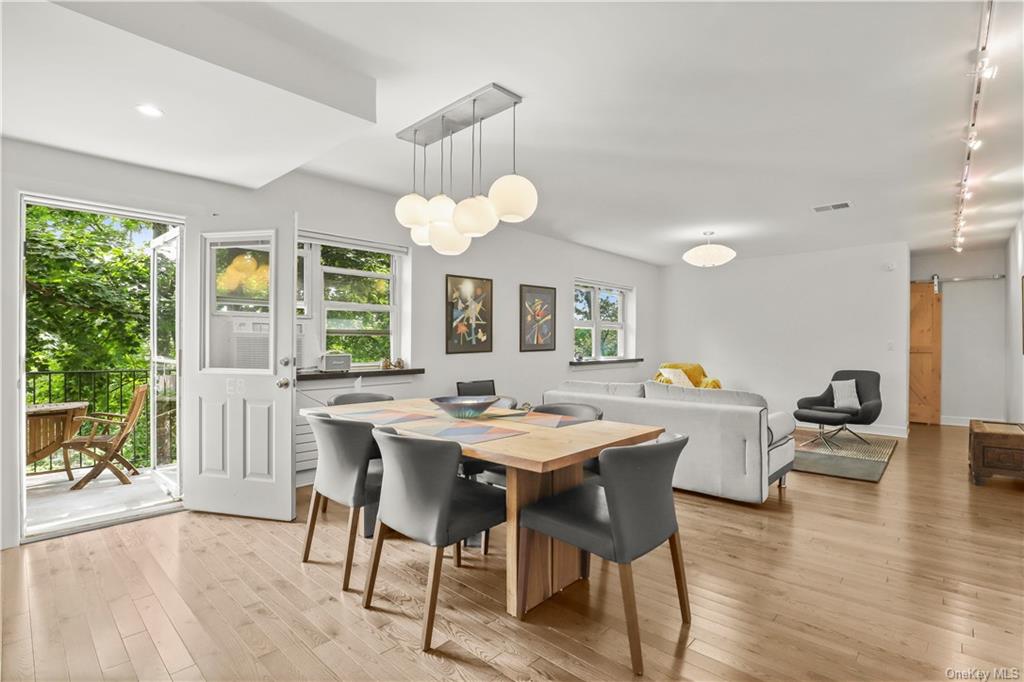 a view of a dining room with furniture wooden floor and chandelier