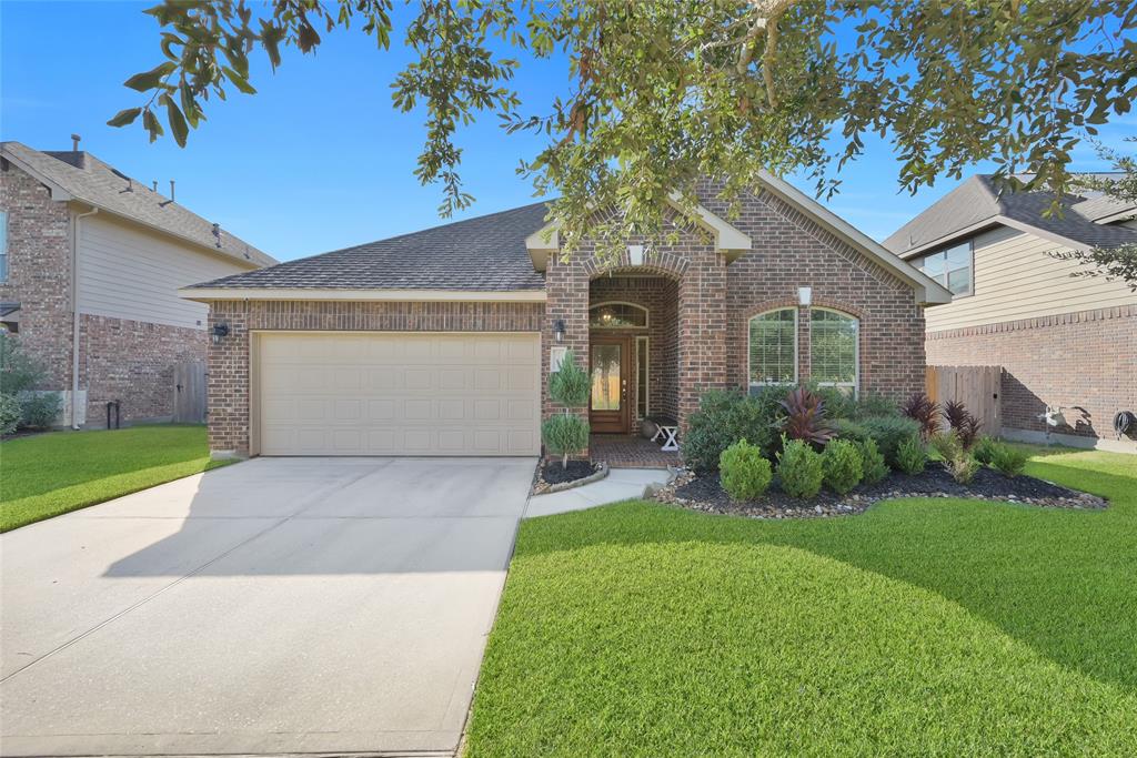 a front view of a house with a yard and garage