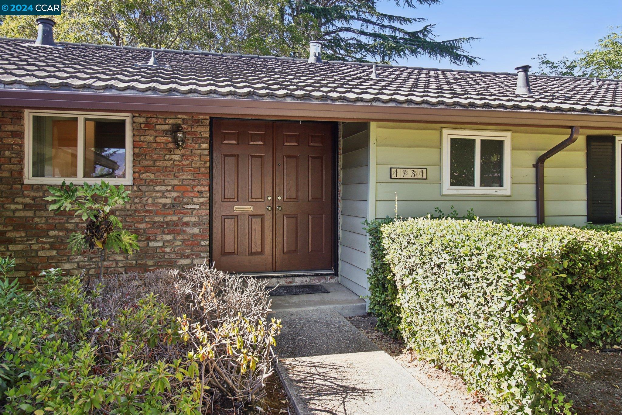 a front view of a house with garden