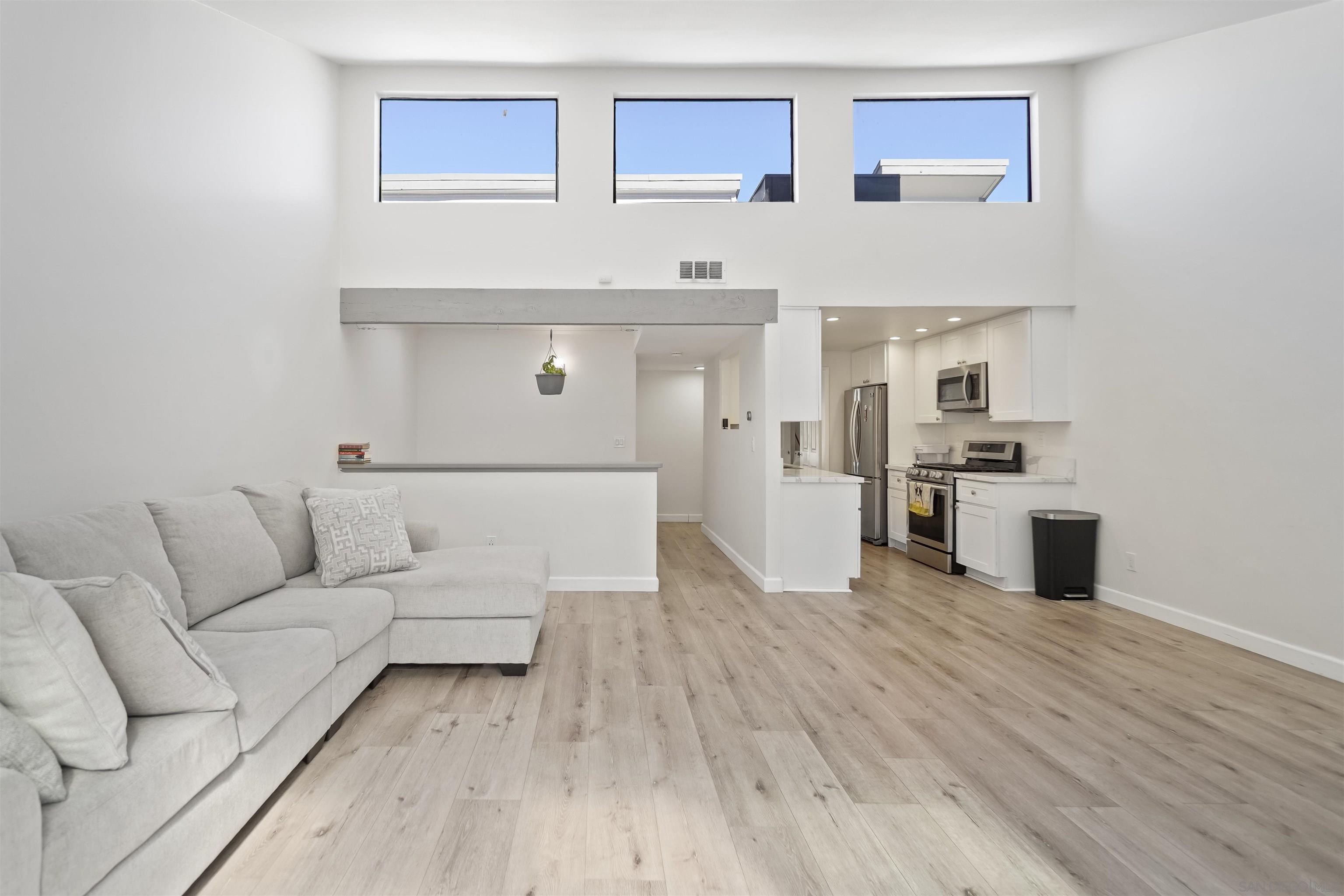 a living room with furniture and kitchen view