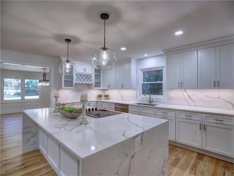 a kitchen with stainless steel appliances granite countertop a sink a counter space and cabinets