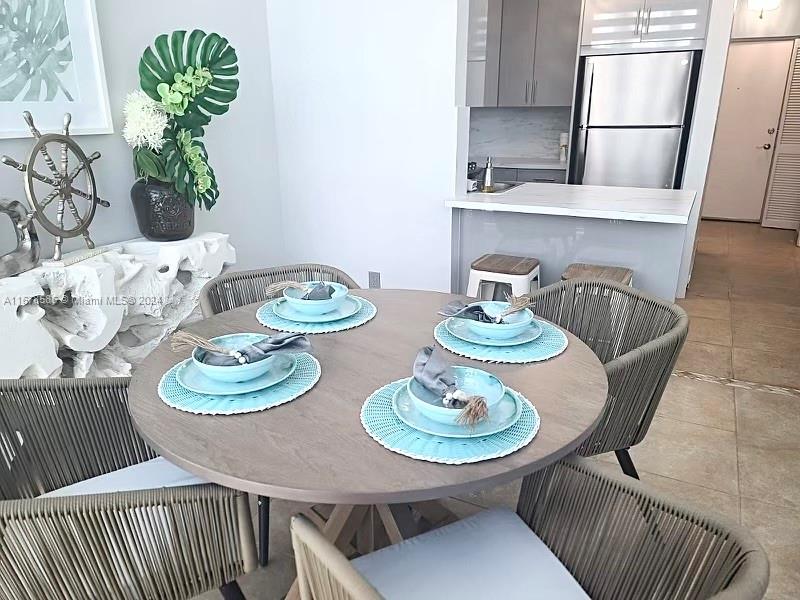 a dining room with furniture a rug and wooden floor