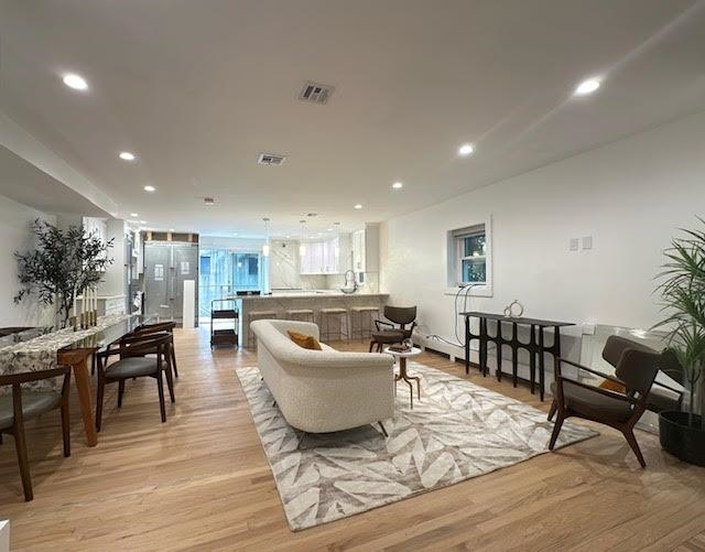 a living room with furniture and a wooden floor