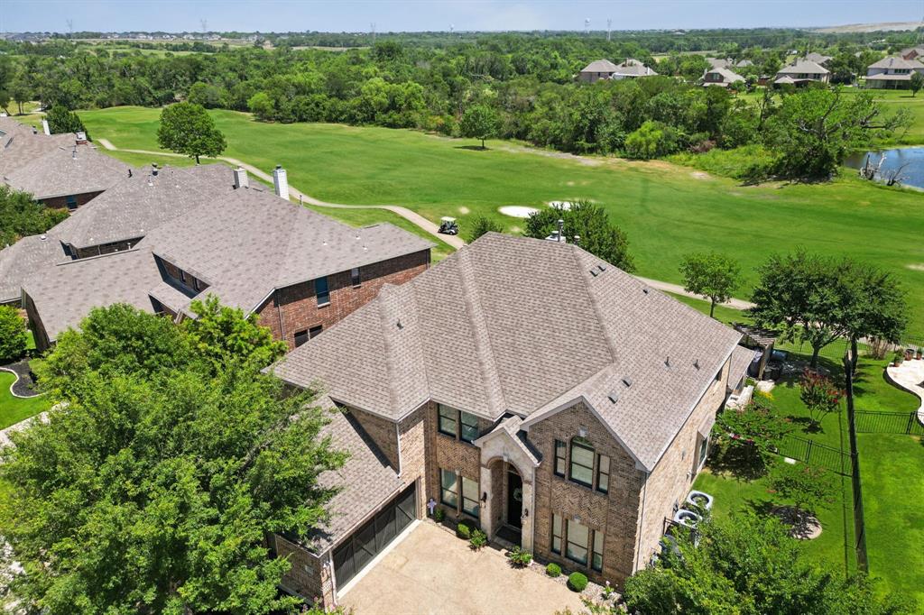 an aerial view of a house with big yard