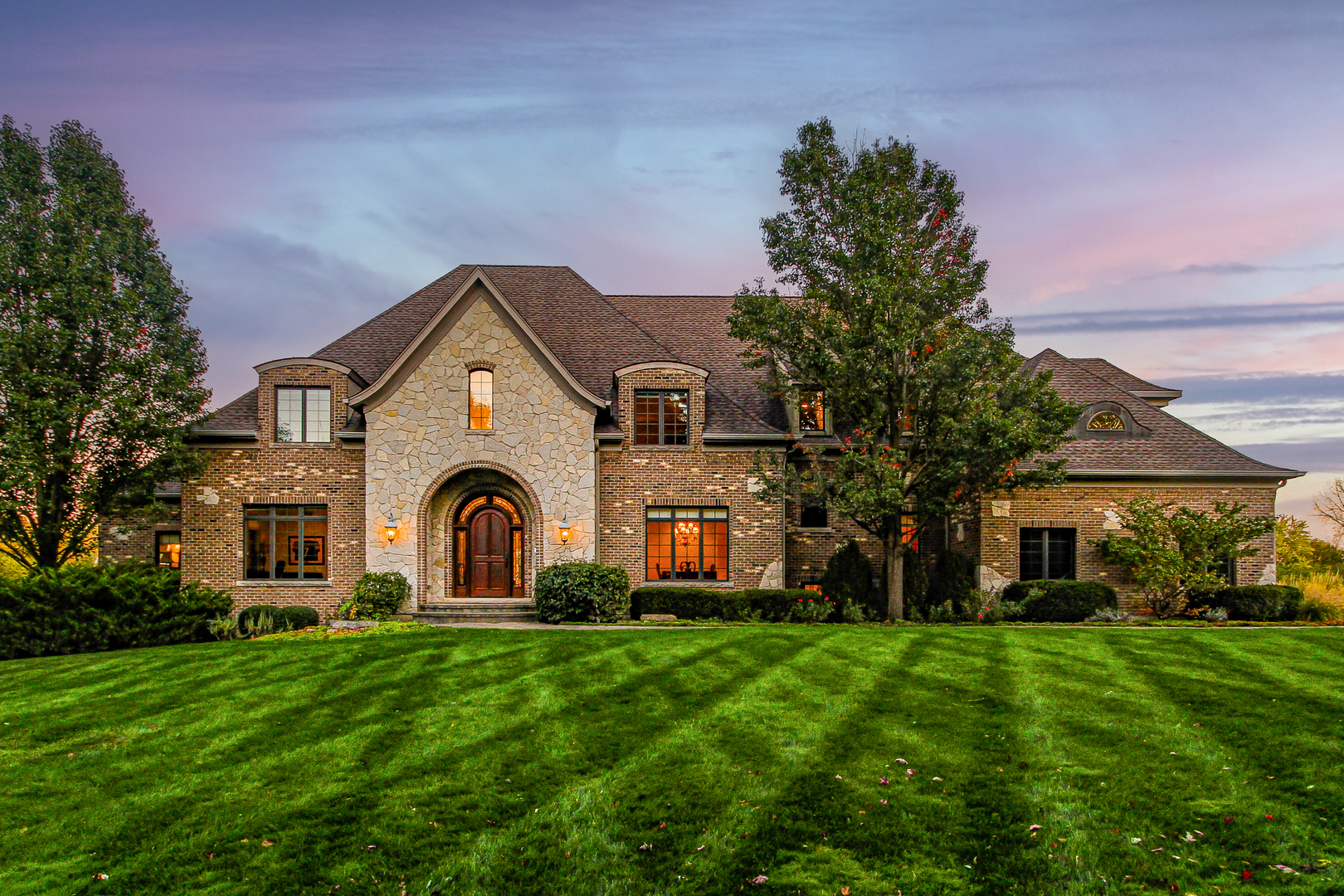 a front view of a house with a garden