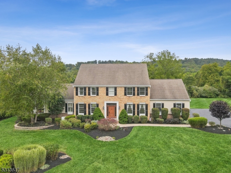 a aerial view of a house next to a big yard and large trees