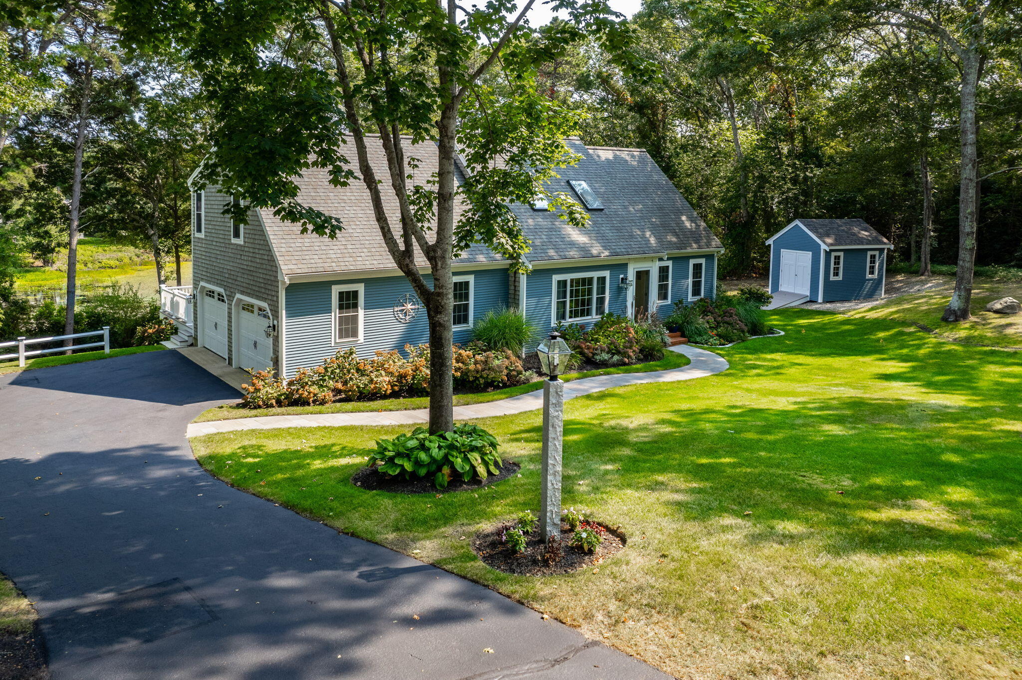 a front view of house with yard and green space