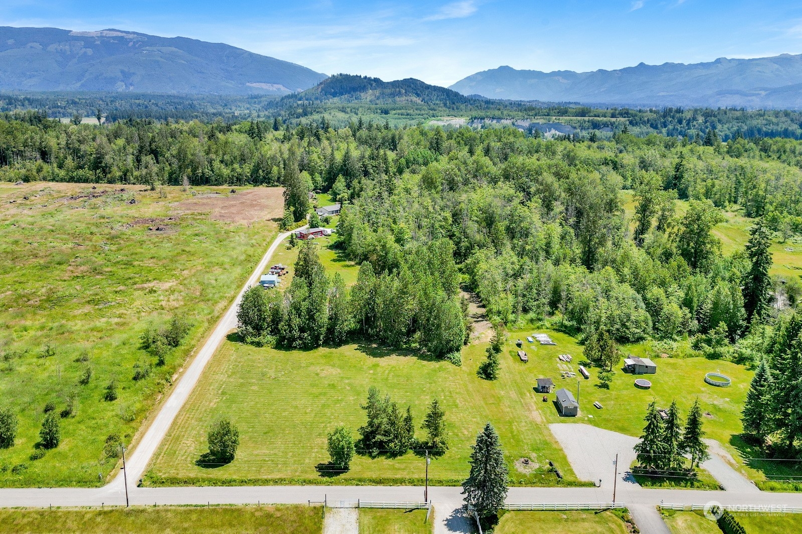 a view of an aerial view of residential houses with outdoor space and trees