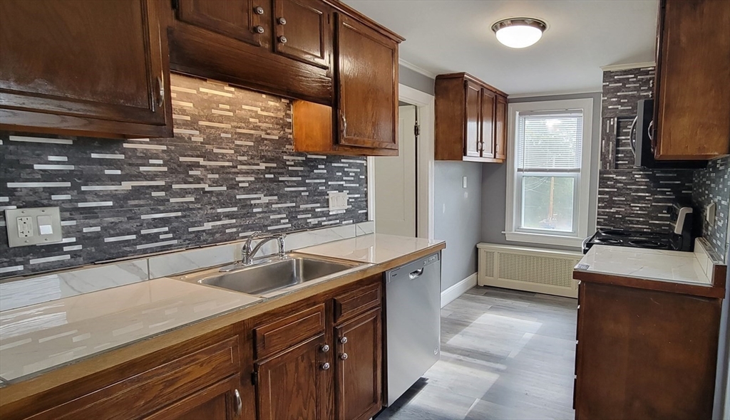 a kitchen with stainless steel appliances a sink and a refrigerator