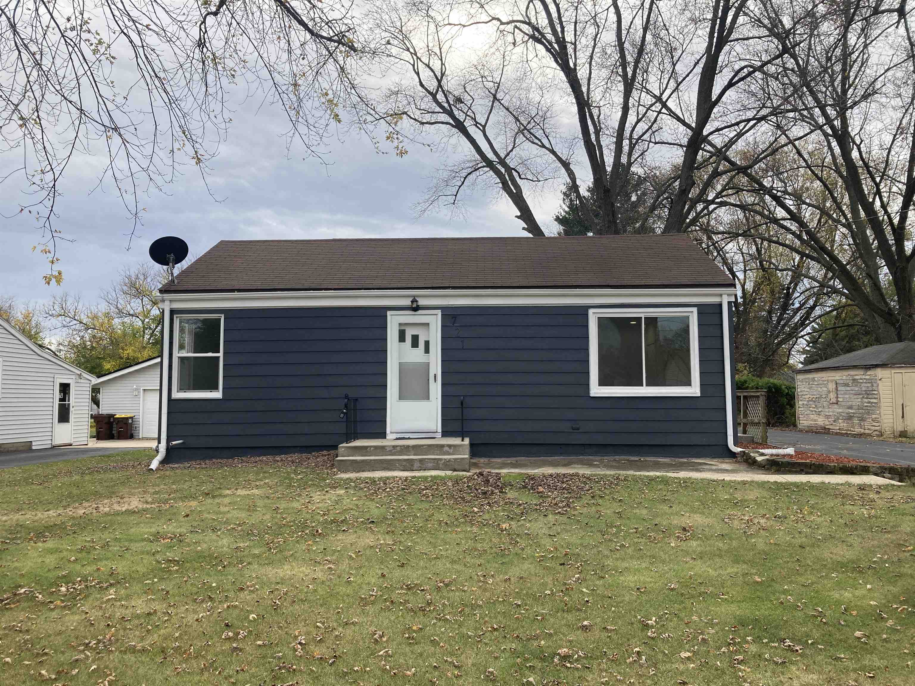 a house that has a tree in front of the house