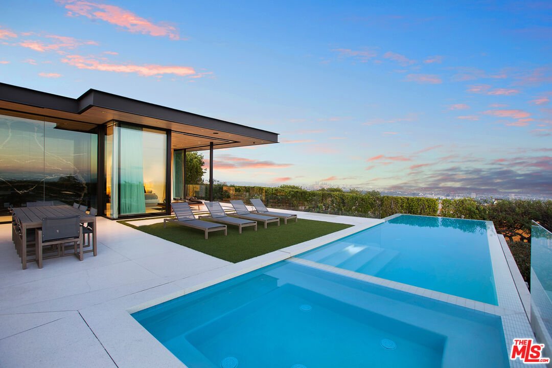 a view of swimming pool with outdoor seating and a yard