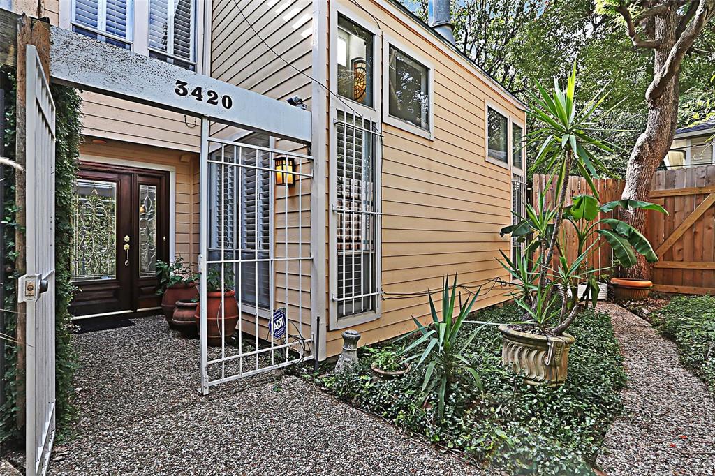 Main entrance to the home from a gated pedestrian walkway